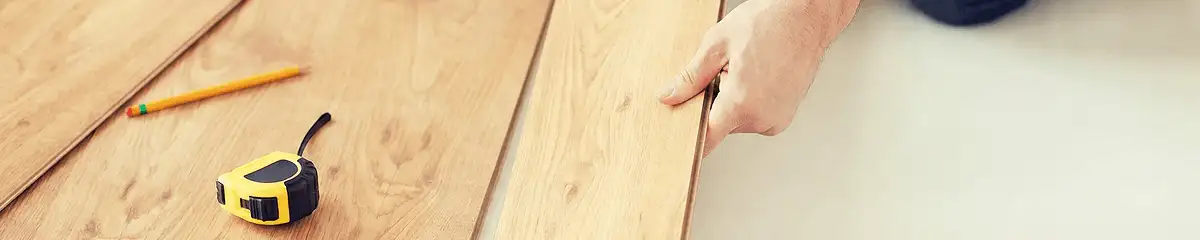 A professional installing wood flooring in Duluth, MN