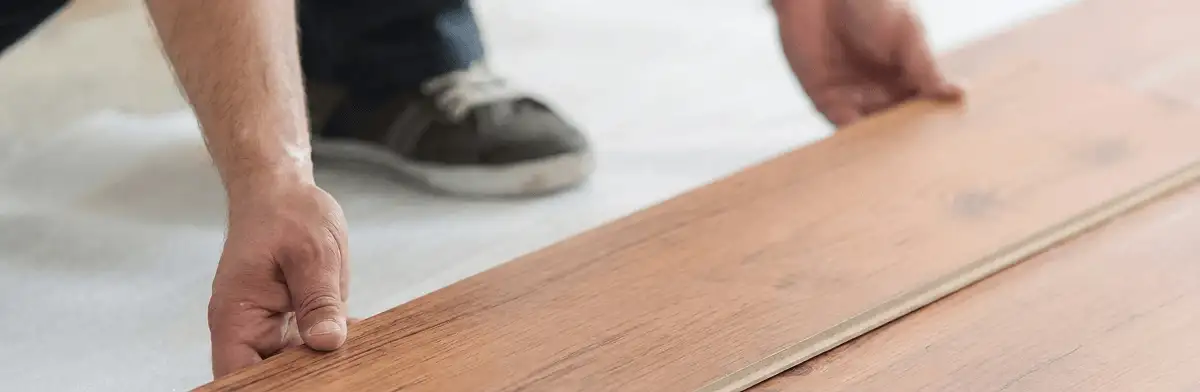 A professional installing laminate flooring in Duluth, MN