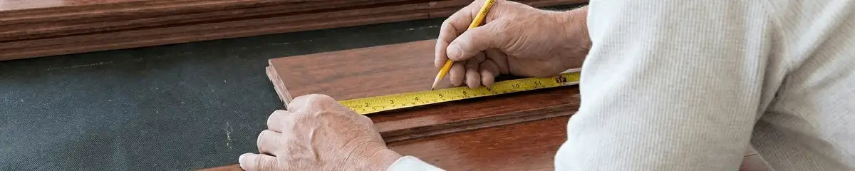 A professional installing wood flooring in Duluth, MN